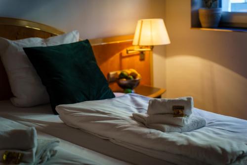 a bed in a hotel room with a towel on it at Hotel Waibstadter Hof in Waibstadt
