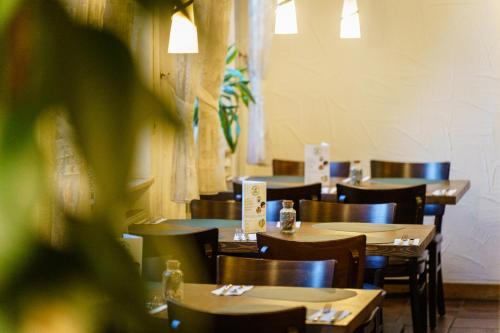 a dining room with wooden tables and chairs at Hotel Waibstadter Hof in Waibstadt