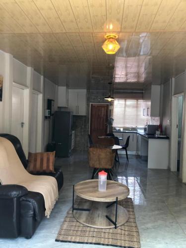 a living room with a couch and a table at Eastern Road Executive Suites in Harare