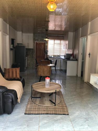 a living room with a couch and a coffee table at Eastern Road Executive Suites in Harare