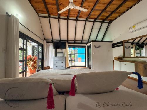 a bedroom with two beds and a couch at Hostal Antawara Tayrona in El Zaino