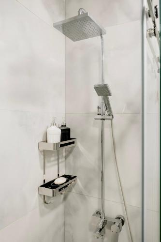a white bathroom with a shower with a lamp at Nest One Luxe, Элитные апартаменты с балконом и видом на фонтан Tashkent City Park 077 in Tashkent