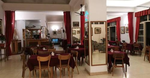 a restaurant with tables and chairs in a room at Hotel Balbi Resort in Mendoza