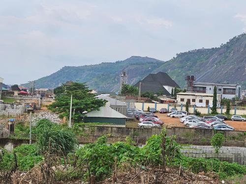 a group of cars parked in a parking lot at Wood Lake Apartment in Dushekoro