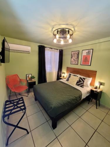 a bedroom with a bed and a red chair at Casa Arbol in La Paz
