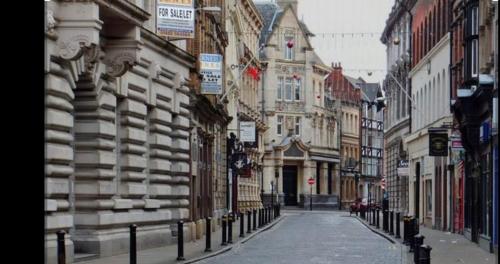 an empty street in a city with buildings at Hull Central Comfort in Hull