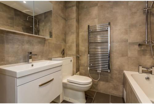 a bathroom with a toilet and a sink at Hull Central Comfort in Hull