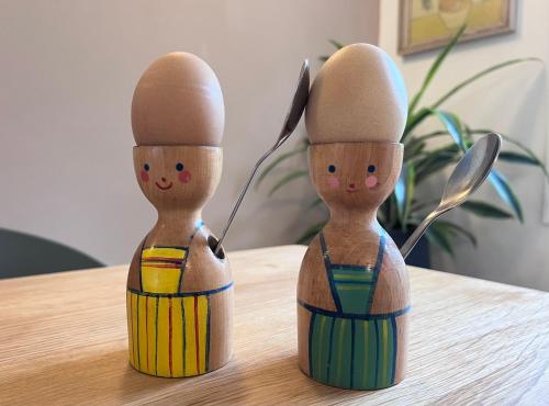 two wooden figurines sitting on top of a table at The Shades - Bliss In The Heart of Windermere in Windermere