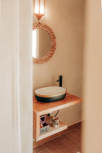 a bathroom with a sink and a mirror at Agafay Yes We Camp Restaurant & Spa in Aït Mazou