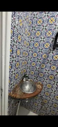a bathroom with a metal sink on a wall at La sirène in Mahdia