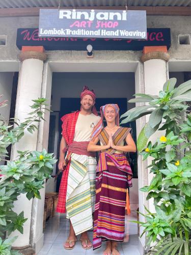 a man and a woman standing in front of a building at Tetebatu flower in Tetebatu