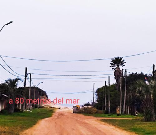 a dirt road with palm trees on it at Lo del Beto in San Gregorio de Polanco
