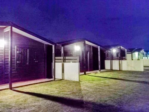 a row of buildings at night with lights at Lo del Beto in San Gregorio de Polanco