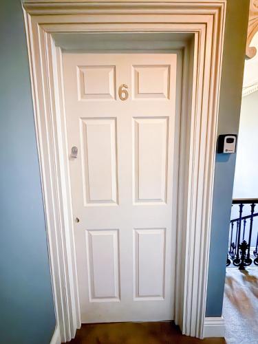 a door in the hallway of a house at City Nights, TV Bed, Free Parking, Nr Plymouth Hoe in Plymouth