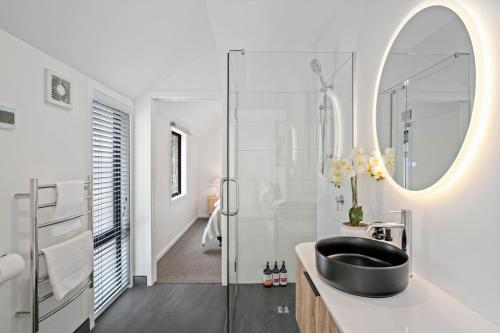 a bathroom with a black sink and a mirror at Central Queenstown Residence in Queenstown