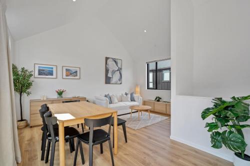 a dining room and living room with a table and chairs at Central Queenstown Residence in Queenstown
