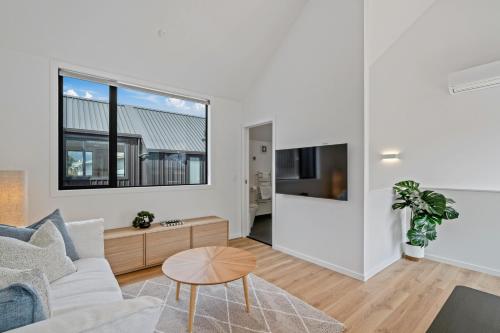 a living room with a couch and a table at Central Queenstown Residence in Queenstown