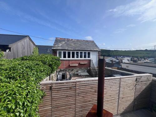 a house on top of a building with a fence at The Boathouse in Salcombe