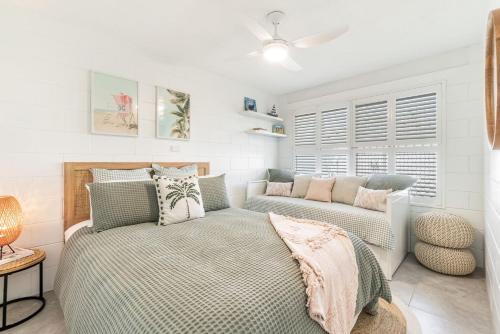 a bedroom with a bed and a couch at Iluka Villa 4 in Iluka