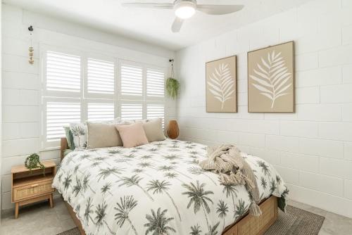 a bedroom with a bed with a palm tree blanket at Iluka Villa 4 in Iluka
