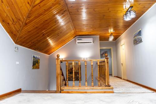 a room with a wooden ceiling and a staircase at ECO ART Hotel in Tashkent