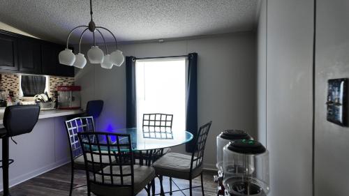 a dining room with a table and chairs in a kitchen at Faith short term rental in Romulus