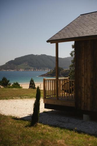 a gazebo on a beach next to a beach at Hórreos de Abrela in O Vicedo