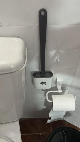 a bathroom with a toilet and a roll of toilet paper at Hogar experience in Macapá