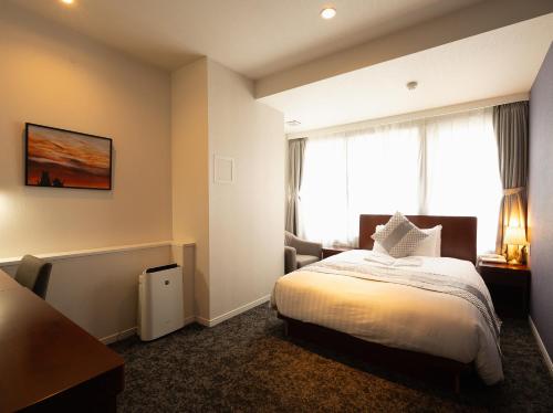 a hotel room with a bed and a window at Hotel Tokyo Trip Ueno Nishi Nippori in Tokyo