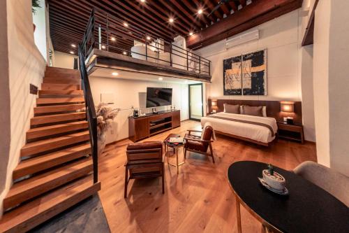 a large room with a bed and a staircase at Domingo Santo Hotel Boutique in Mexico City