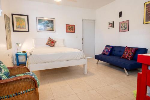 a bedroom with a bed and a couch at Studio 1 Tinima with Garden access in Vieques