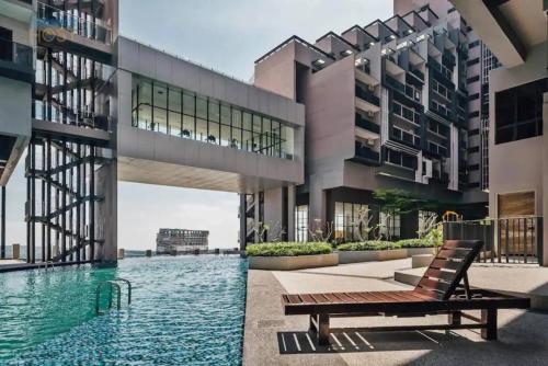 a view of a building with a pool and a bench at Maxhome Suites at Imperio Melaka in Malacca