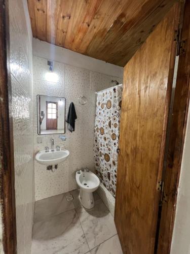 a bathroom with a sink and a toilet at Cabañas del Sur in Mar del Plata
