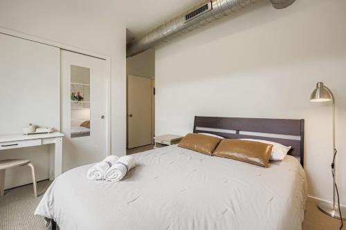 a bedroom with a bed with two towels on it at SoCo Haven - Stylish Stay - Sleeps 8 & Wifi in Austin