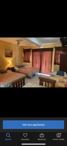 a picture of a hotel room with two beds at Casa central in San Juan del Sur