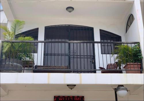 a building with a balcony with plants on it at Casa central in San Juan del Sur