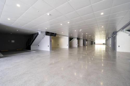 a large empty room with a concrete floor and white ceilings at Gimhae Hotel Hiem in Samgong