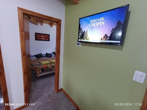a room with a flat screen tv on a wall at Cabana del aeropuerto calafate in El Calafate