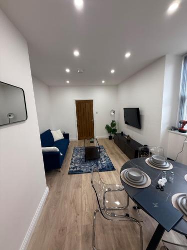 a living room with a blue table and a couch at Modern 2 Bedroom Flat - Central & Stylish in Newcastle upon Tyne