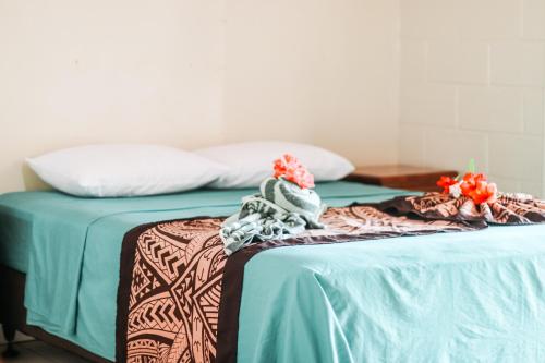 Postel nebo postele na pokoji v ubytování Hotel Millenia Samoa