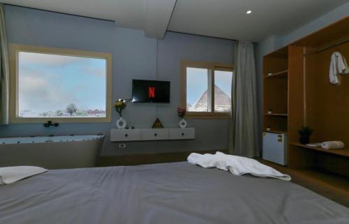 a bedroom with a large bed and a bath tub at The kings of pyramids view inn in Cairo