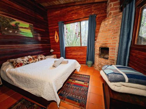 a bedroom with a bed and a fireplace at Refugio Santa Elena in Santa Elena