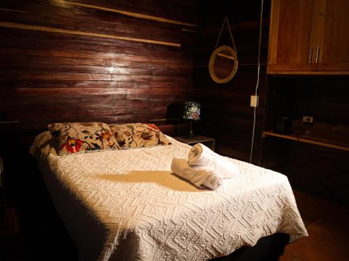 a bedroom with a bed with a towel on it at Refugio Santa Elena in Santa Elena