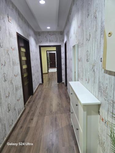 a hallway of a room with wooden floors and walls at شقه مؤثثة بالشوقية in An Nikāshah