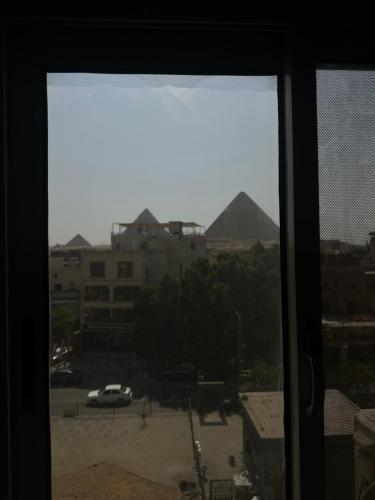 a view from a window of a parking lot at The kings of pyramids view inn in Cairo