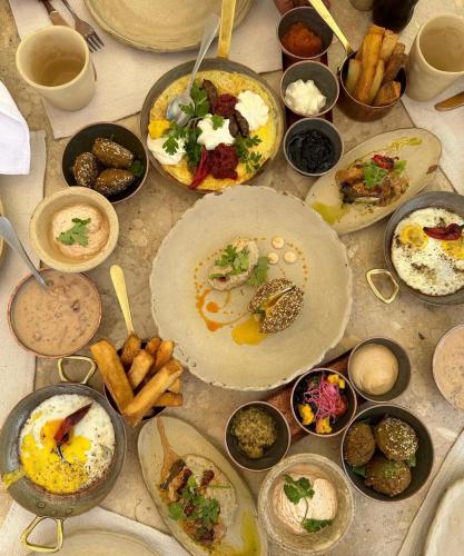 a table with many plates of food on it at The kings of pyramids view inn in Cairo