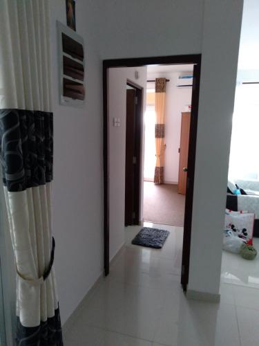 a living room with a hallway and a door with a curtain at Mystical Rose in Malabe