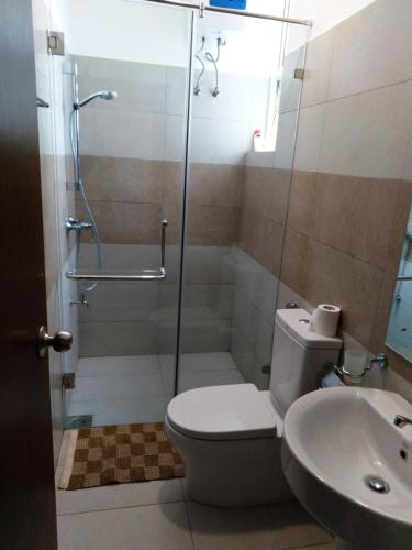 a bathroom with a shower and a toilet and a sink at Mystical Rose in Malabe