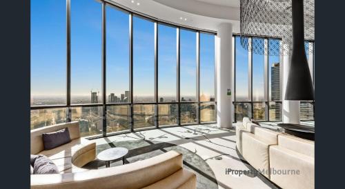 a living room with a view of the city at Prima Tower - Premium Apartment with City and Flames Views in Melbourne