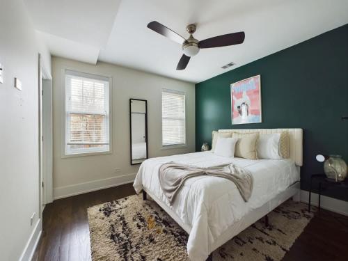 a bedroom with a large bed with a ceiling fan at Loft with Chefs Kitchen a Balcony and Onsite Parking in Chicago